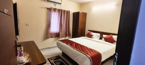 a hotel room with a bed and a window at Star Light Suites in Bangalore