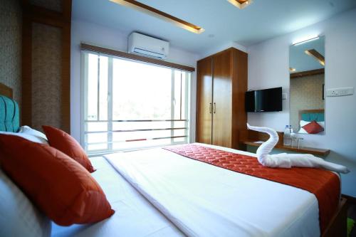 a bedroom with a large bed with a white bird on it at Hills & Cruise Luxury Houseboats in Alleppey