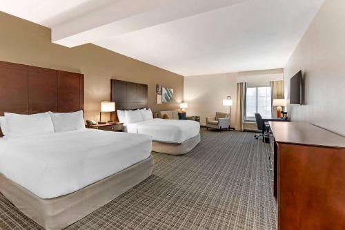 a hotel room with two beds and a desk at Comfort Inn & Suites Verona at Turning Stone Resort Casino in Verona