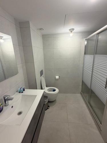a bathroom with a toilet and a sink and a shower at sea&sky luxury suite מילה דירות אירוח in Eilat