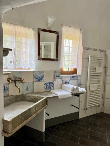 a bathroom with a sink and a mirror at Agriturismo Coppi Rossi in Imperia