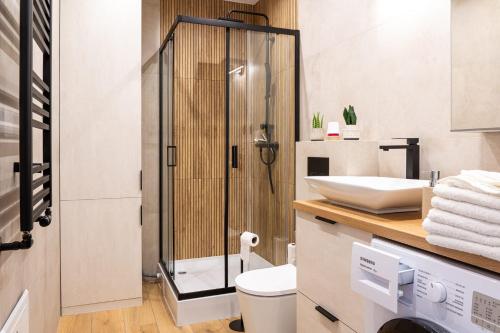a bathroom with a shower and a toilet and a sink at Apartament 16 in Sandomierz