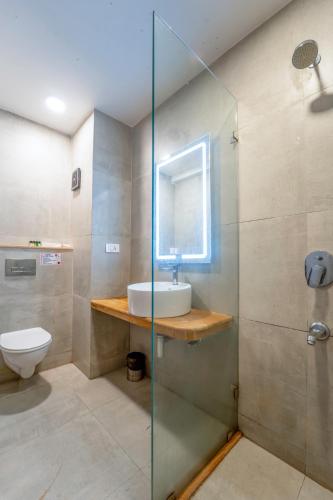 a bathroom with a sink and a toilet at Sia Signature Calangute in Calangute