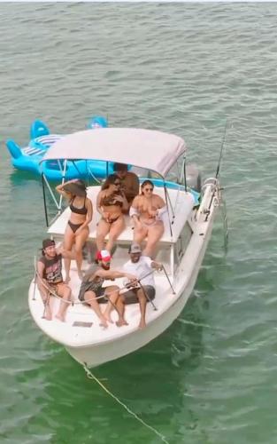 a group of people sitting on a boat in the water at Tour Full Day Taboga in Panama City