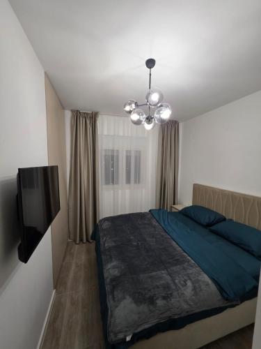 a bedroom with a bed and a flat screen tv at A&A Apartment in Šušanj