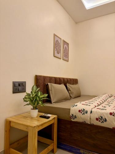 a bedroom with a bed and a table at Yatha sukham Prutham in Ujjain