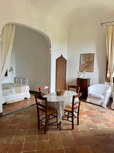 a room with a table and chairs and a bed at Agriturismo Coppi Rossi in Imperia