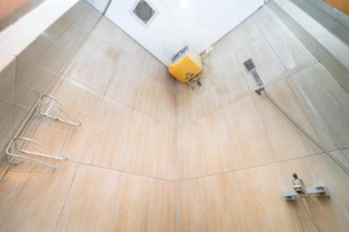 an overhead view of a bathroom with a yellow vacuum at Tempuran Suites By ARBA in Kejayan