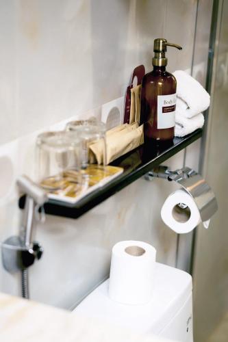 a shelf above a toilet in a bathroom at Sunlight Hotel Coron in Coron