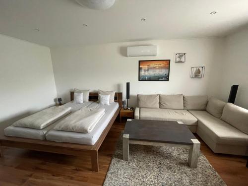 a living room with a bed and a couch at Gellénia in Balatonberény