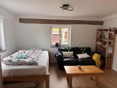 a living room with a bed and a couch at FEWO in Spielberg in Sachsenheim