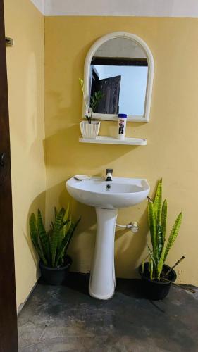 a bathroom with a white sink and a window at JA Villa in Pottuvil