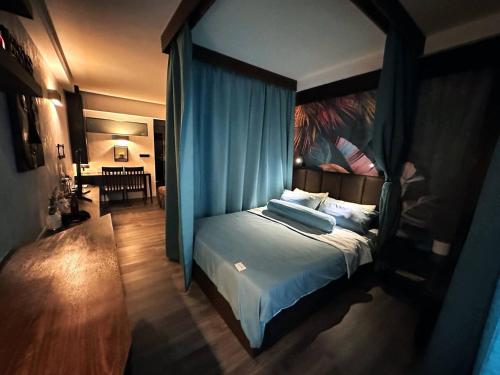 a bedroom with a bed with a blue canopy at Resort-Style 1BR-Epic Pool View-Walk to Beach in Bophut