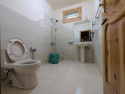 a bathroom with a toilet and a sink at Hunza Lounge in Hunza Valley