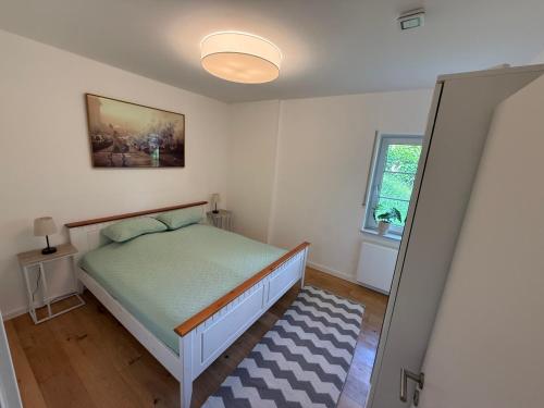 a small bedroom with a bed and a window at Wohnung in Saarburg in Saarburg