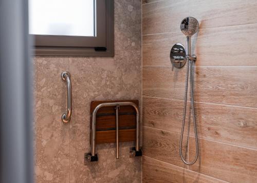 a shower with a shower head in a bathroom at The Wave in Limenaria