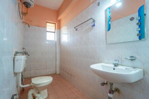 a bathroom with a toilet and a sink at Vasco Residency in Vasco Da Gama