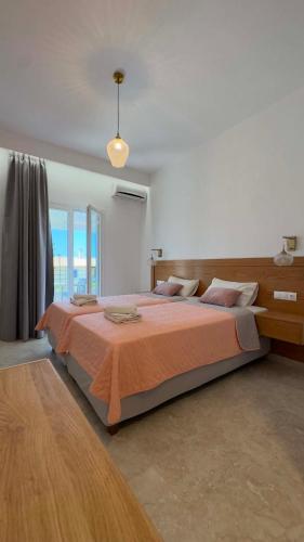 una camera da letto con un grande letto e una grande finestra di Villa Sofia ad Acharavi
