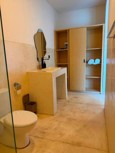 a bathroom with a toilet and a sink at Volcano Bliss Villa Kintamani in Kintamani