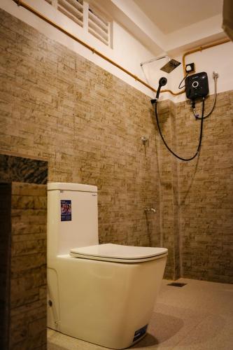 a bathroom with a toilet and a camera on the wall at Mi Casa Coastal Villa in Akurala