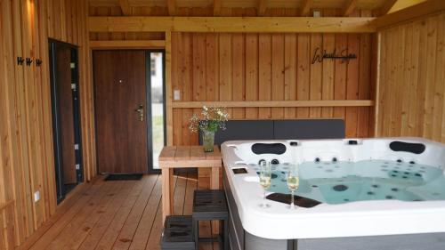 a bath tub in a room with wooden walls at Ferienhof Schmalzgrub in Böbrach