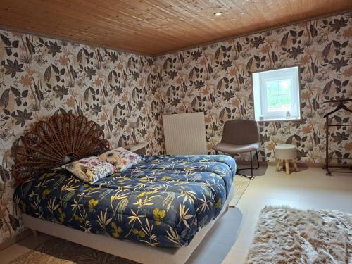 a bedroom with a bed in a room with wallpaper at Domaine de la Bréssandière in Châtillon-sur-Thouet