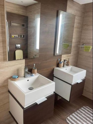 a bathroom with a white sink and a mirror at Beautiful villa with pool KELIBIA in Kelibia