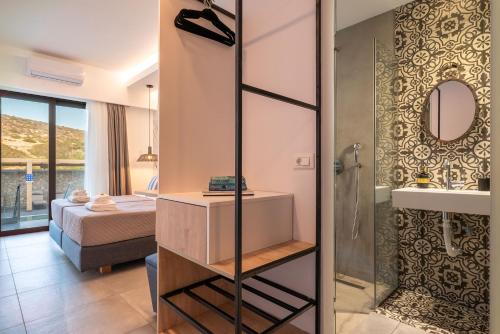 a bathroom with a shower and a bedroom with a bed at Prasonisi Lighthouse Studios in Prasonisi