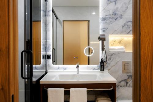 a bathroom with a sink and a mirror at Air Kostanay in Kostanay