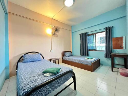 a bedroom with a bed with a cat laying on it at J Home in Ao Nang Beach