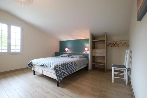 a bedroom with a bed and a book shelf at Hergarai in Saint-Jean-le-Vieux