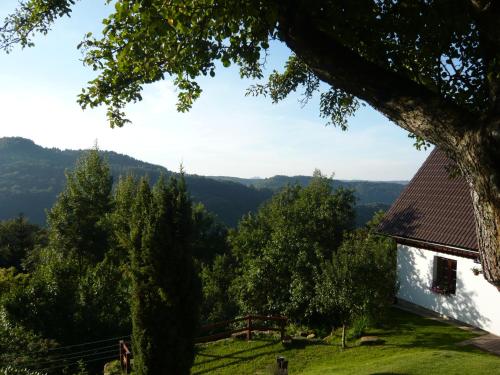 a white house on a hill with a view at Chalupa Záborčí in Malá Skála