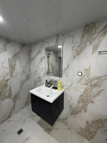 a white bathroom with a sink and a mirror at Boho style house Varna in Varna City