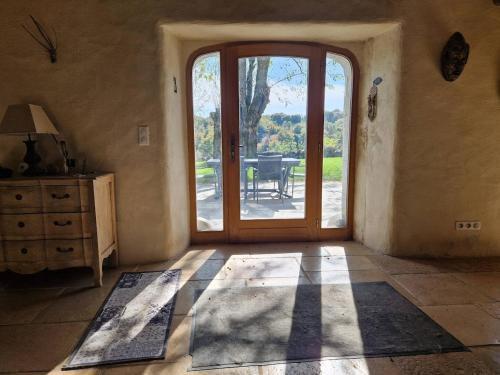 a room with a door leading to a patio at La Borie de Peyrot in Huparlac