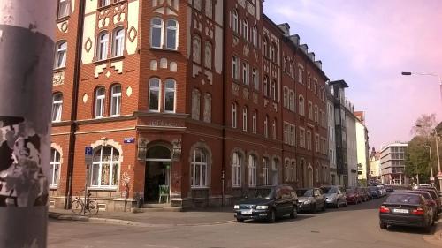 a large brick building with cars parked in front of it at Apartment Lawrenz in Erfurt