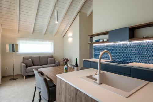 a kitchen with a sink and a living room at Conero Azzurro in Numana