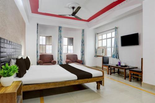 a bedroom with a bed and a desk and a tv at Hotel Welcome Palace in Patna