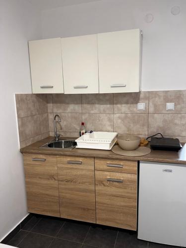 a kitchen with white cabinets and a sink at Salt & Sea in Sykia Chalkidikis