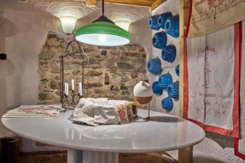 a white table in a room with a lamp and balloons at Grashöfle in Höhenbrunn
