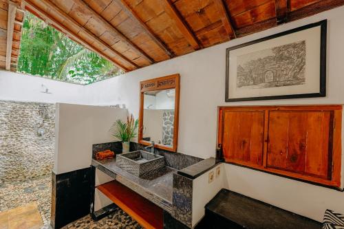 a bathroom with a sink and a mirror at Sikepan Villa Borobudur in Mendut