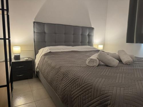 a bedroom with a large bed with a large headboard at Lemon Tree Residence in Artemida