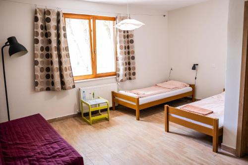 a room with two beds and a window at Kentaur Guesthouse in Atea