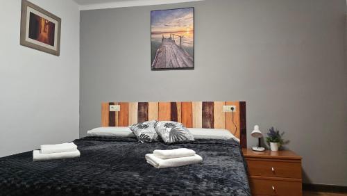 a bedroom with a bed with two towels on it at Fonda Angeleta in Valderrobres