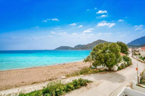 a view of the beach from the balcony of a condo at Komi Shoreline Blue Window in Kómi