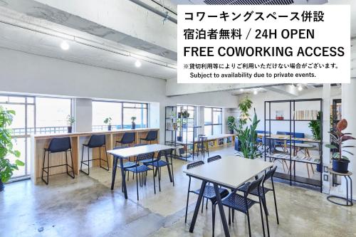 an office with tables and chairs and a sign that reads free computing access at DELTA HOSTEL in Akita