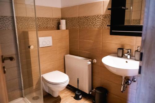 a small bathroom with a toilet and a sink at Kentaur Guesthouse in Atea
