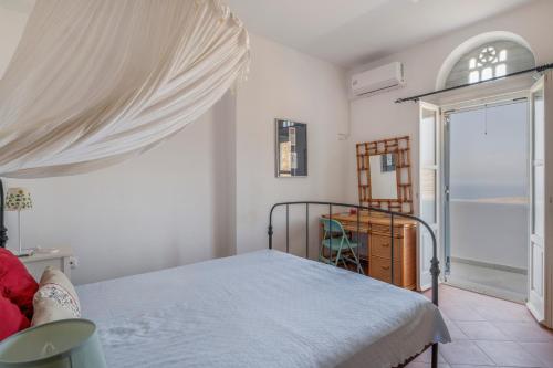 a bedroom with a bed and a sliding glass door at Tinos Sunset House in Tinos