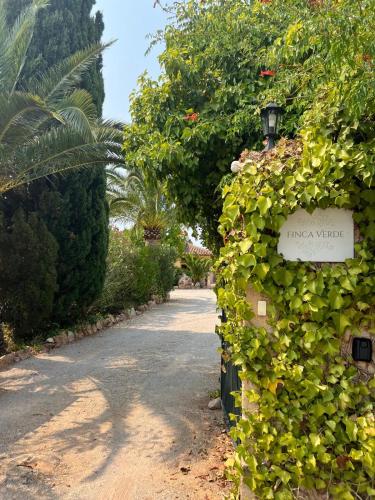 an entrance to a garden with a green hedge at Finca Verde in Llucmajor