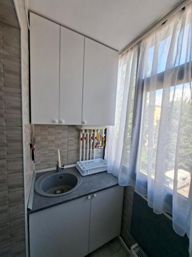 a kitchen with a sink and a window at Exclusiv new family in Năvodari