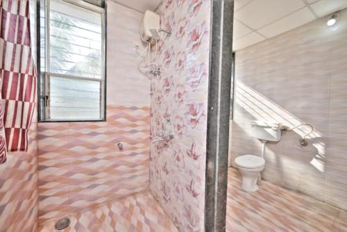 a bathroom with a shower with a toilet and stairs at I EMPYREAN STAYS ll MYSTICAL STONE VILLA ll 4BHK II AC II PRIVATE POOL II in Lonavala